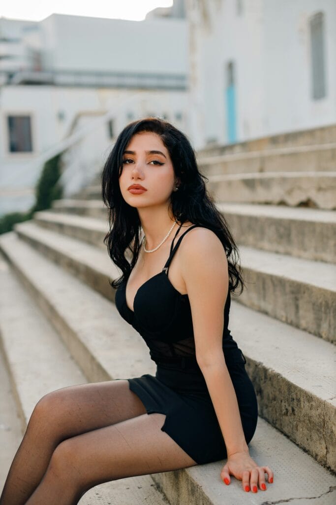 ESCORT SERVICE IN DLF GURGAON A bottle of champagne and roses elegantly arranged on a hotel bed for a luxury outcall.